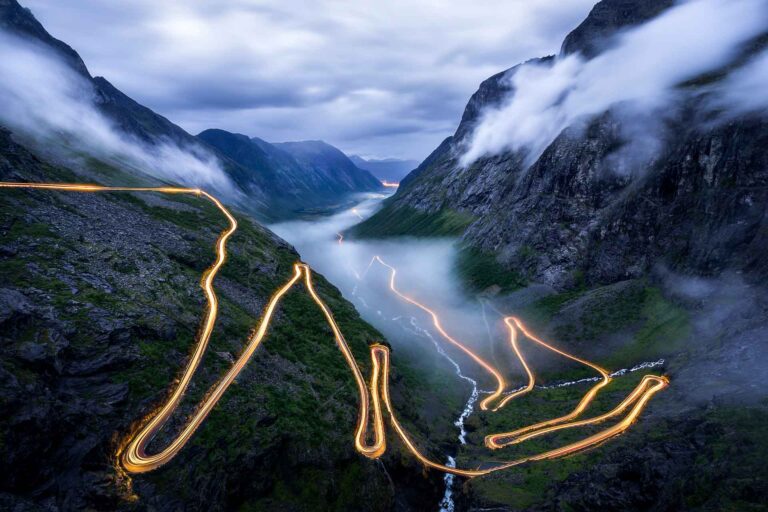 The Must-See Fjords of Western Norway 7 Trollstigen at night. Norway road with lights