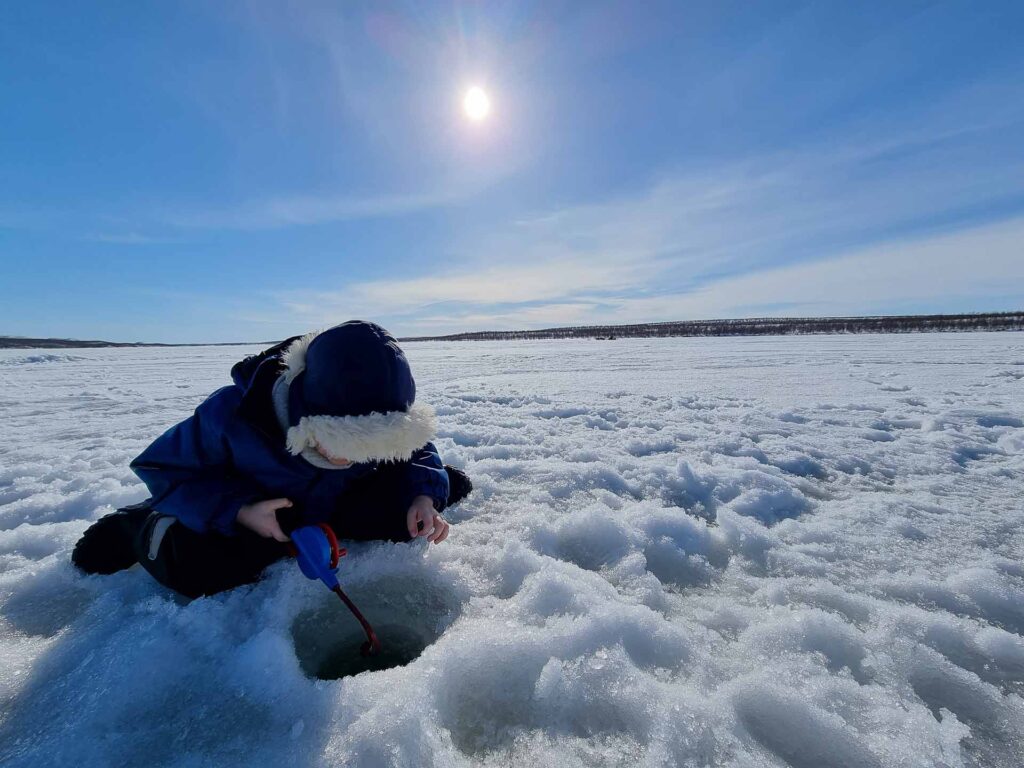 Winter in the Arctic, North Norway. Icefishing kids