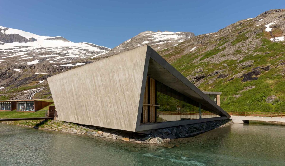 Modern triangle building of Trollstigen cafe and visitor center in front of the mountains. Norway