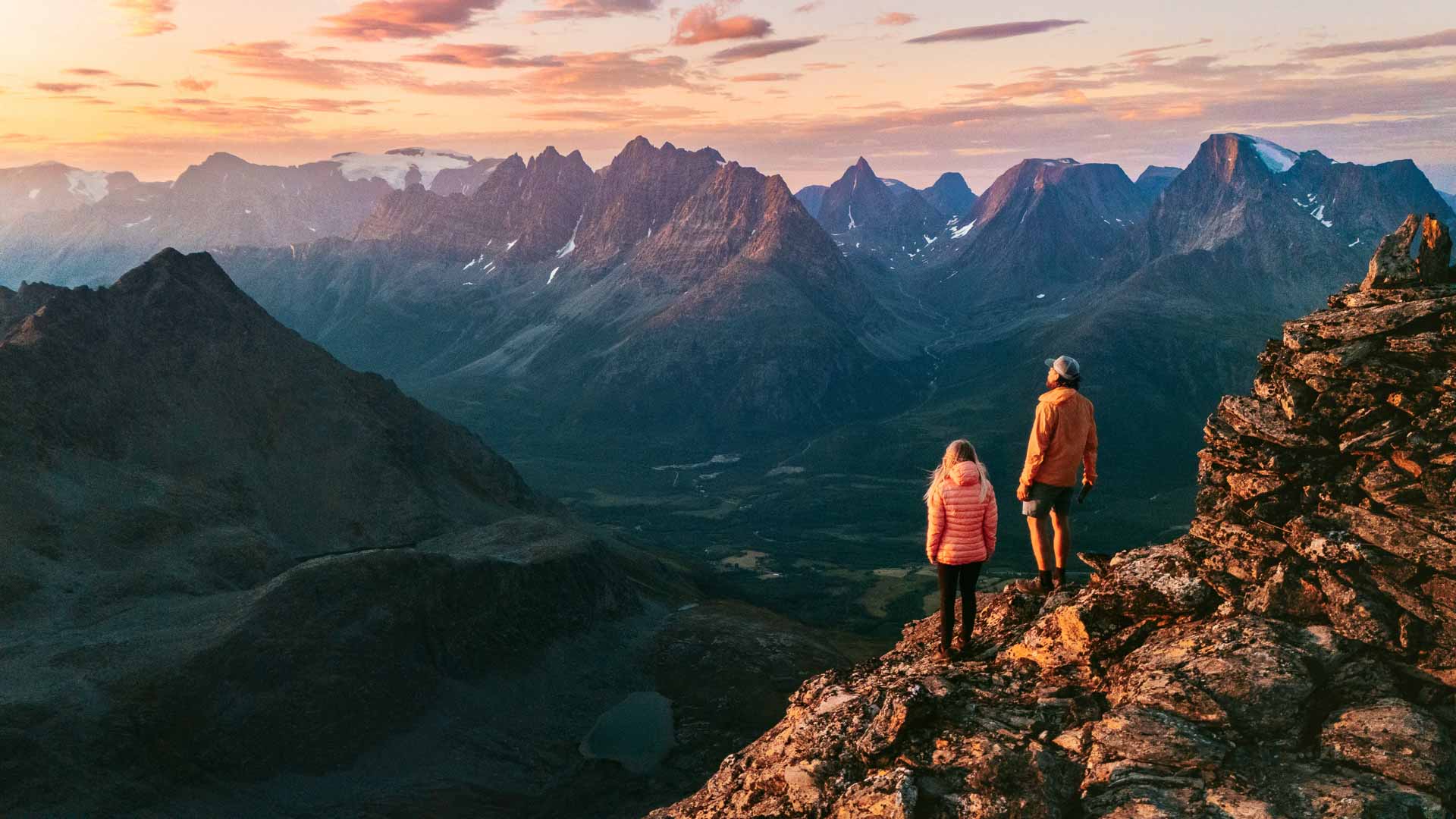 Tromsø Travel Guide 20 Couple friends climbing mountains in Norway man and woman traveling together, active vacations healthy lifestyle family hiking outdoor extreme adventure trip in Lyngen Alps, people enjoying landscape