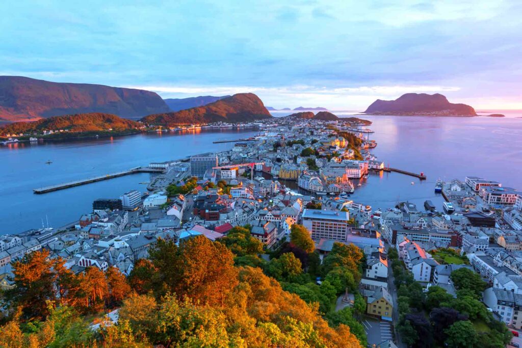 Colorful sunset in Alesund port town on western coast of Norway. Place where the ocean meet the mountains